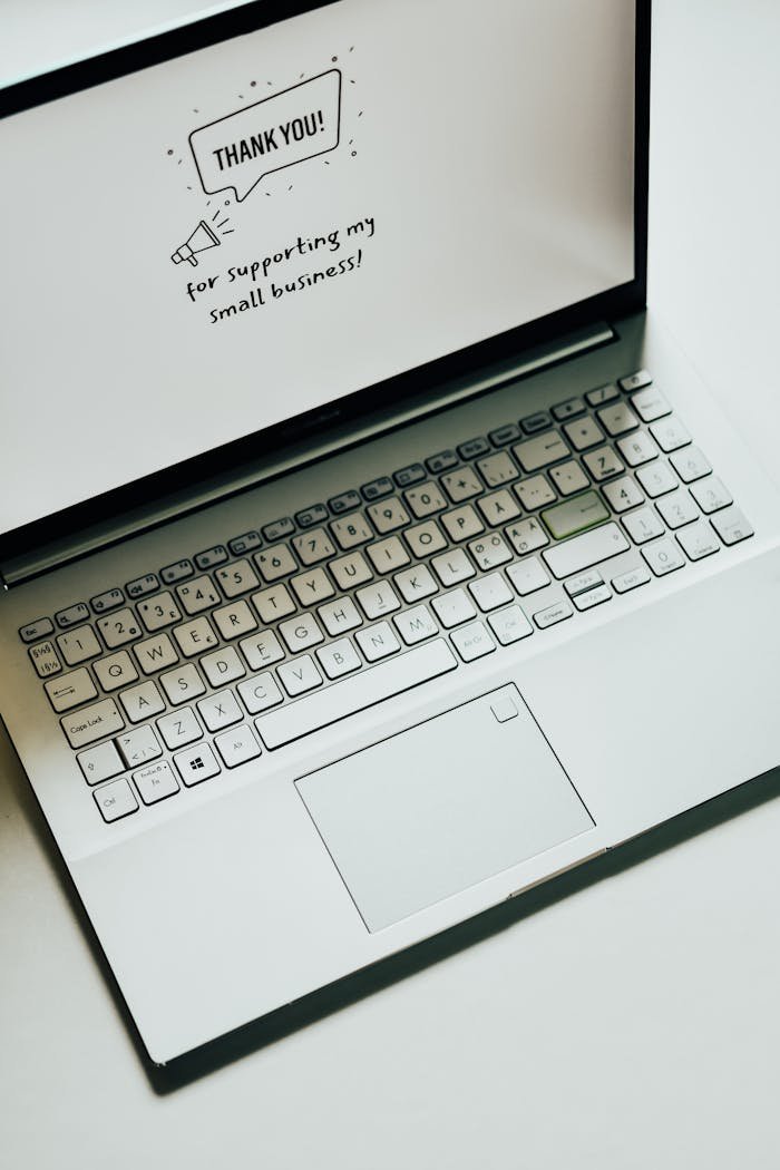 This close-up image shows a laptop displaying a thank you message for supporting small businesses.